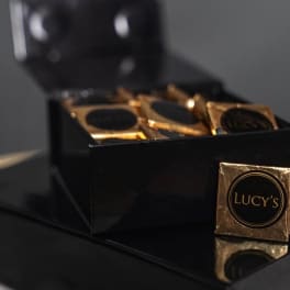 Box of gold-wrapped chocolates with Lucy's labels
