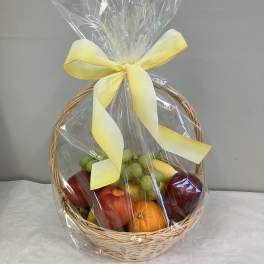 Fruit basket wrapped in clear cellophane with a yellow ribbon