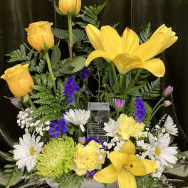 Yellow roses and lilies with white daisies in a low arrangement