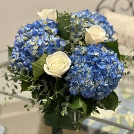 Blue hydrangea bouquet with white roses in a vase