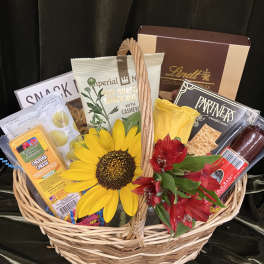 Gift basket with snacks, chocolates, and yellow and red flowers