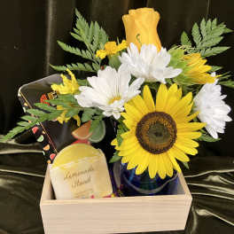 Sunflower and white daisy bouquet in a blue vase with a soap bar and card in a wooden box
