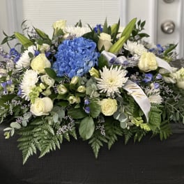 Blue hydrangea and white roses in a low floral arrangement