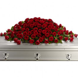 Red rose casket spray on a silver casket
