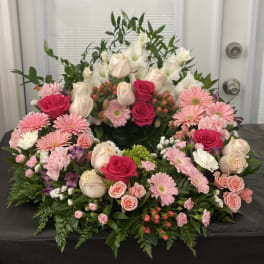 Large pink and white floral arrangement with roses and daisies