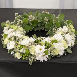 White and green floral wreath with daisies and carnations