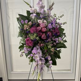 Tall purple and pink floral standing spray on an easel