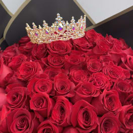 Bouquet of red roses with a jeweled crown topper