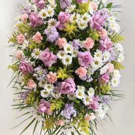 Large standing spray of pink roses, white daisies, and pastel flowers