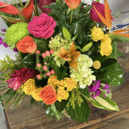 Colorful mixed bouquet with roses, orchids, and green mums