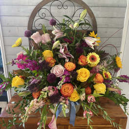 Large mixed bouquet with roses, lilies, and gerbera daisies in a vase