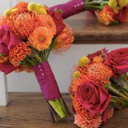 Two pink and orange bridal bouquets with roses and mums
