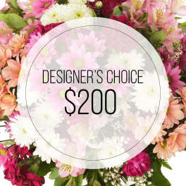 Mixed pink and white flowers surrounding a designer's choice $200 label