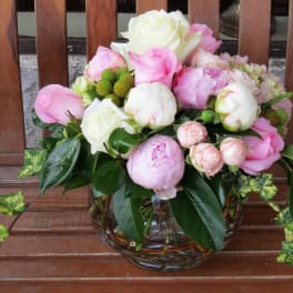 Pink and white flower arrangement in a glass vase