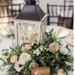 Wedding table centerpiece with a lantern and pastel flowers