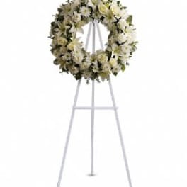 White floral wreath on a standing easel