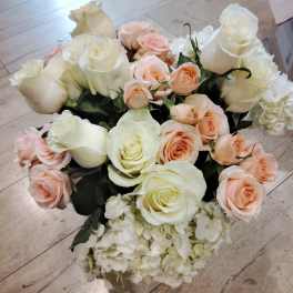Bouquet of white and blush roses with white hydrangea