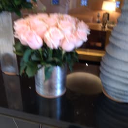Bouquet of pale pink roses in a silver vase