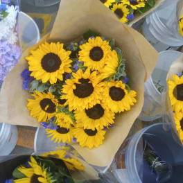 Bouquet of yellow sunflowers wrapped in brown paper