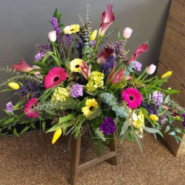 Large mixed floral arrangement with pink, yellow, purple, and white blooms