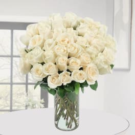 Bouquet of white roses in a clear glass vase