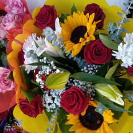 Bouquet of red roses and sunflowers with white accent flowers
