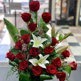 Red roses and white lilies in a compact bouquet