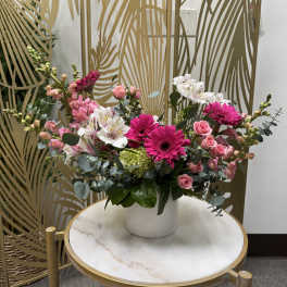 Pink and white mixed flower arrangement in a white vase