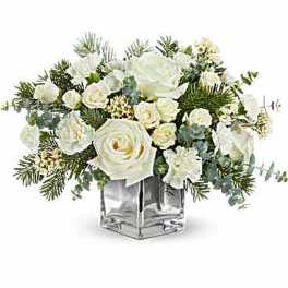 White rose arrangement in a clear square vase