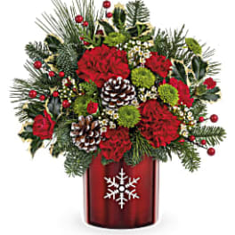 Christmas bouquet in a red vase with pinecones and red flowers
