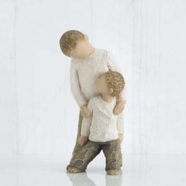 Two carved figurines of a parent and child standing together