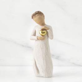 Small angel figurine holding a gold heart