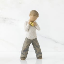 Small figurine of a child holding a gold heart