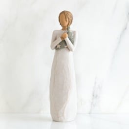 Decorative figurine of a girl holding a small star-patterned cloth