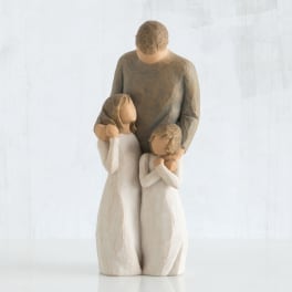 Wooden figurine of a man with two children embracing