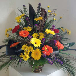 Colorful mixed flower arrangement in a bronze vase
