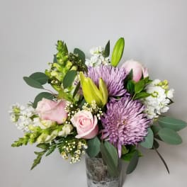 Pink roses and purple chrysanthemums in a glass vase