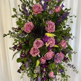 Tall standing floral spray with pink roses and purple blooms