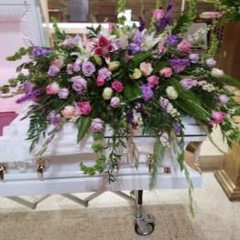 Large casket spray with pink, purple, and white flowers