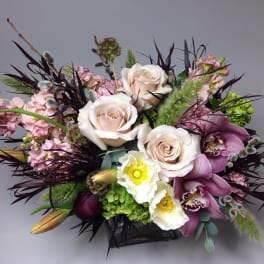 Mixed bouquet with pale roses, purple orchids, and white blooms