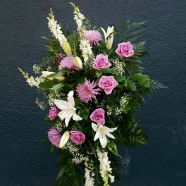 Standing floral spray with pink roses, white lilies, and white snapdragons