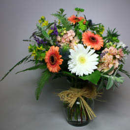 Bouquet of gerbera daisies and mixed flowers in a glass vase