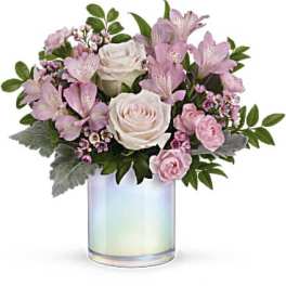 Pink and white flowers arranged in an iridescent glass vase