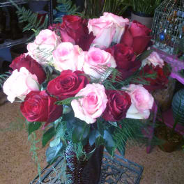 Bouquet of red and pink roses in a dark vase
