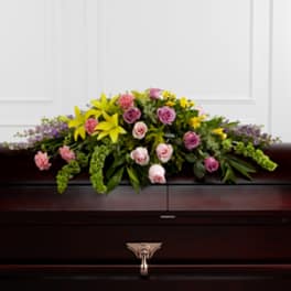 Casket spray with yellow lilies and pink roses