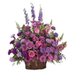 Basket arrangement of pink and purple flowers