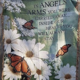 Memorial blanket with white daisies, butterflies, and a remembrance message