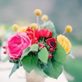 Small bouquet of pink, red, and yellow flowers in a vase