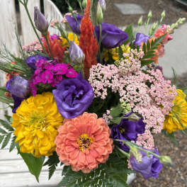 Colorful bouquet with purple, yellow, and coral flowers