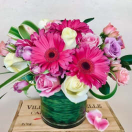 Pink and white mixed bouquet in a green glass vase